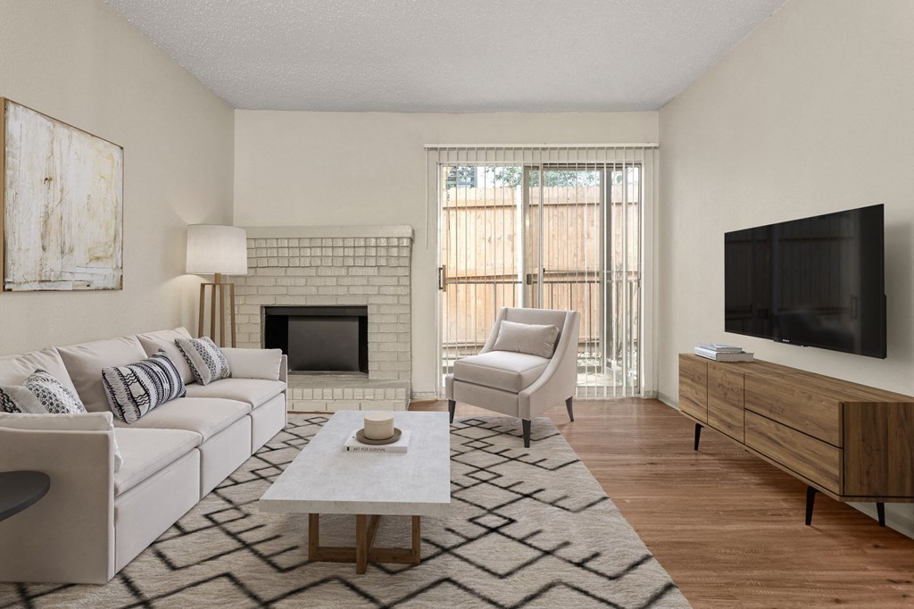 a living room with a white couch and a fireplace and a tv at South Lamar Village, Austin